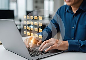 A person working on a laptop. DMS or ECM concept, digital folders, and data management systems