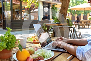 person working on laptop in outdoor caf setting