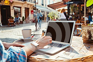 person working on laptop in outdoor caf setting