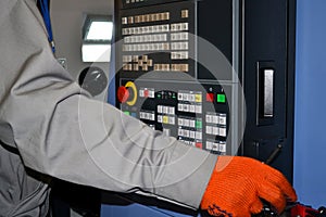 Person works behind the control panel of the production machine