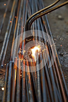 A person works with welding, sparks, close up, construction