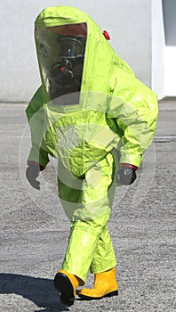 Person with yellow protective suit to manage hazardous materials