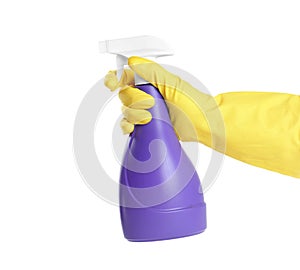 Person in yellow rubber gloves with spray detergent on background, closeup of hand