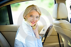Personal assistant and driver. Business life concept. Business woman sit on backseat. Busy lady passenger leather car