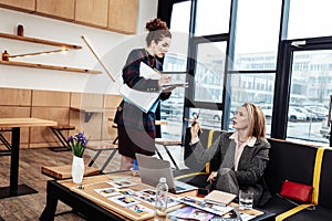 Personal assistant listening to very influential businesswoman