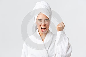 Personal care, women beauty, bath and shower concept. Close-up of mad young asian woman in bath towel and bathrobe