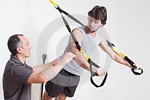 Personal coach explaining suspension training