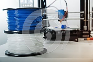 Personal 3d printer and abs or pla filament coils next to him.. photo