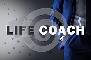 Personal development concept. Businessman and phrase Life Coach on grey background, closeup