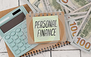 PERSONAL FINANCE text on a paper with keyboard on grey background.