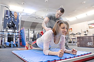 Personal fitness trainer working exercise with mature woman in the gym. Health fitness sport age concept