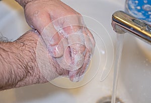 Personal hygiene and prevention of the coronavirus pandemic wash men`s hands