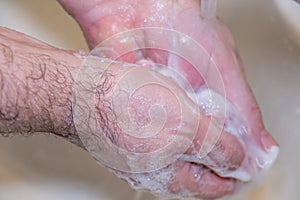 Personal hygiene and prevention of the coronavirus pandemic wash men`s hands