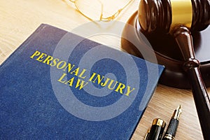 Personal injury law on a desk and gavel.