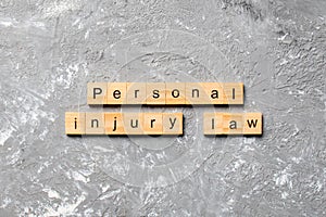 Personal injury law word written on wood block. personal injury law text on table, concept