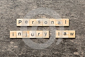 personal injury law word written on wood block. personal injury law text on table, concept