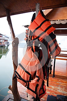 Personal life support flotation safety device life jacket, life vest, work vest, life saving, buoyancy aid or flotation suit for photo