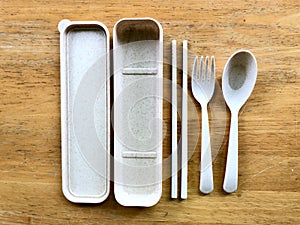 Personal plastic utensils set on wooden table