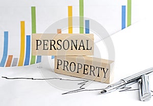 PERSONAL PROPERTY text on a wooden block on chart background , business concept
