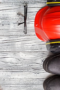 Personal protective equipment: black gloves goggles glasses on a wooden background