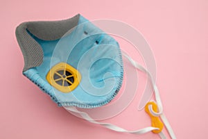 Personal protective equipment mask on pink background