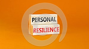 Personal resilience symbol. Concept word Personal resilience typed on wooden blocks. Beautiful orange table orange background.