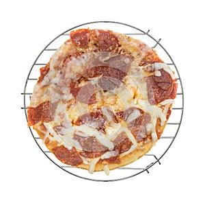 Personal size pepperoni pizza on a wire rack