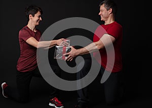 Personal Trainer couple handing a gift box