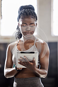 Personal trainer with digital tablet, mobile wellness technology in gym and black woman exercise in fitness gym. Sports