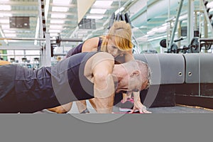 Personal trainer encouraging muscle man in push