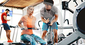 Personal trainer giving instructions in gym