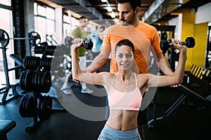 Personal trainer giving instructions in gym