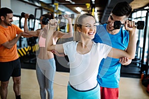 Personal trainer giving instructions in gym