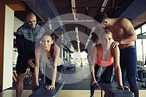 Personal trainer giving instructions in gym