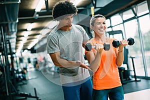 Personal trainer giving instructions in modern gym