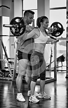 Personal trainer helping woman at gym