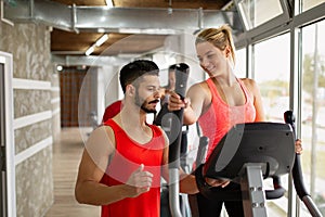 Personal trainer helping a woman to working out in gym. Sport people healthy lifestyle concept