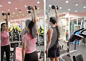 Asian chinese woman in gym lifting weights