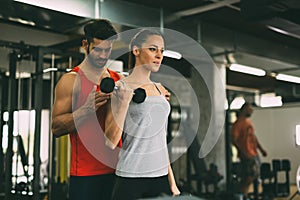 Personal trainer instructing trainee