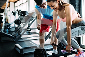 Personal trainer instructing trainee