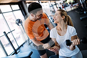 Personal trainer instructing trainee