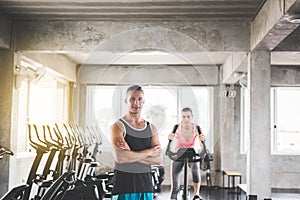 Personal trainer man crossed arms and coaching woman exercise workout in gym,Concept healthy and lifestyle