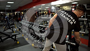 Personal trainer preparing training site for his clients gym, sport profession