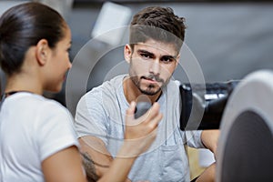 personal trainer showing time to sportsman