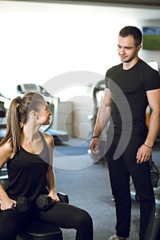 Personal trainer talks to his client.