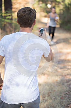 Personal trainer timing female runner