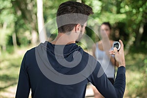 Personal trainer timing female runner