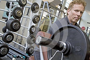 Personal trainer working biceps on a bench