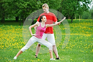Personal training. fitness instructor exercising woman outdoors