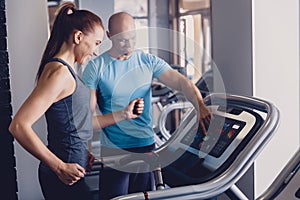 Personal training with a trainer on a treadmill